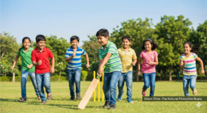  ndian children playing cricket in a sunny park with text overlay "Green Time: The Natural Protective Brake," highlighting the importance of sunlight in preventing myopia.